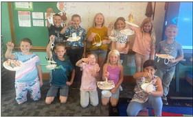 Second graders build bird feeders