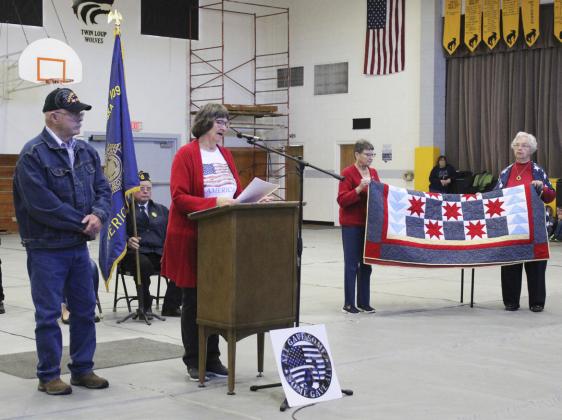 Top left: American Legion Post #109 chaplain Frank Harding (still serving at 101-years-old) gave the invocation and the benediction at the Mullen Veterans Day program on Nov. 10. Bottom left: 8th grader Emerson Thorberg and 7th grader Abby Gracey sang the Star Spangled Banner. Above: Jon Harding’s Quilt of Valor presentation by Eva Crawford, Sue Bonesteel and Doris Starr. Turn to page 3 to read about how Harding served our country.