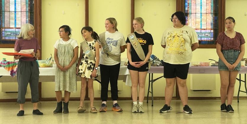 Junior and Cadette Girl Scouts, l-r: leader Sooky Marks, Natalee Walker, Finley Mundorf, Ella Walz, Ava Walz, Pandora Gray, Annabelle Casillas.