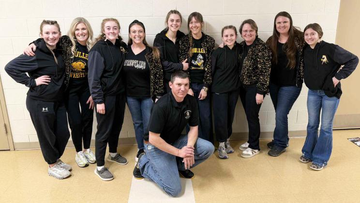 The Mullen High School girl wrestling moms showed up with some extra sparkle at District wrestling February 6-7. Moms and their daughters are pictured with Coach Zack Cox - who definitely needs his own sparkle now! Pictured l-r: Hope and Tami Miller, Kassidy and Joni Cheever, Georgia Wingebach and Rebecca Garrett, Audrabell and Robyn Werth, team mom Erin Cox with student manager Olivia Cox. courtesy photo