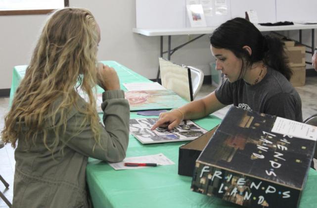 Izabella Brown discusses one of her 4-H entries with the judge. Gerri Peterson