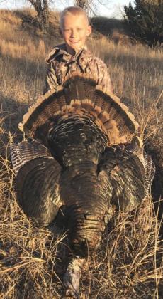 7-year-old Teal Peterson, son of Dane and Gerri Peterson of Mullen, with his first turkey that he shot last month.