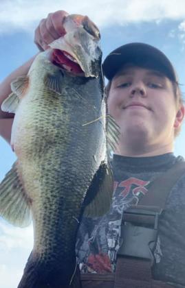 Koby Walker with a bass he caught.