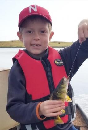 Wade Daugherty, son of Alan and Brandi Daugherty from Valentine, with a perch he caught at the refuge. Wade is the great-grandson of Jan Furrow.