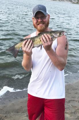 Brandon Newman with a Merritt Reservoir catfish.