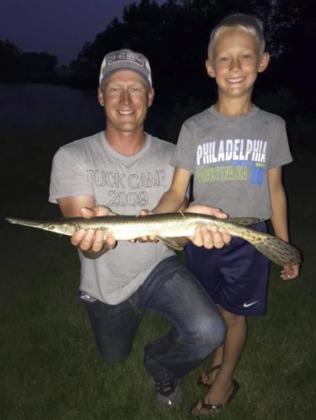 7-year-old Teal Peterson (pictured with his dad, Dane) caught his 16th species of Nebraska fish with this gar this summer.