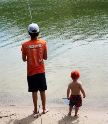 Jasper Roseberry, age 13, sharing his love of fishing with Lanham Volz, age 2, at Merritt Reservoir in July.