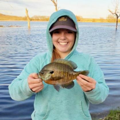 Kassidy Roseberry with a bluegill she caught at a Sandhills lake in northern Cherry County. The smile says it all!