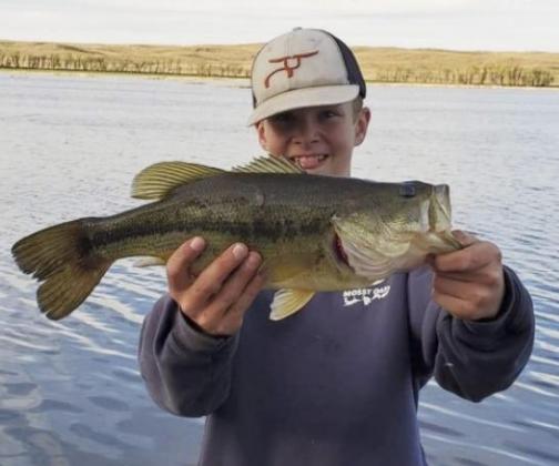 Jasper Roseberry with a largemouth bass he caught in a Sandhills lake in northern Cherry County.