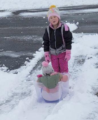 Kinley and Kyla Crisp improvised for a sled!
