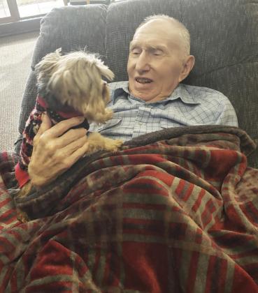 Jerry Carson enjoying some Bentley time. Chris Baker, RN, brought Bentley with her to work.