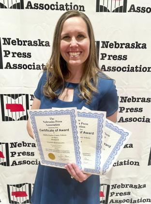 Gerri Peterson with her Better Newspaper Contest awards last Saturday in Lincoln. Amy Johnson