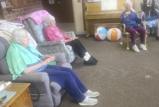 L-r: Marty Boyer, Marlene Dykes and Wanda Mackley doing some finger exercises with Rebecca.