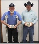 Will Donohoe (left) and Don Cox received buckles for their years of trapshoot help.