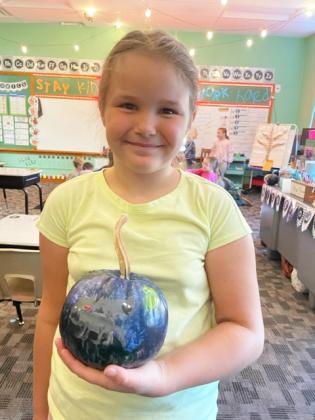 The 2nd grade students recently painted pumpkins. Pictured is Kaleah Heaton.
