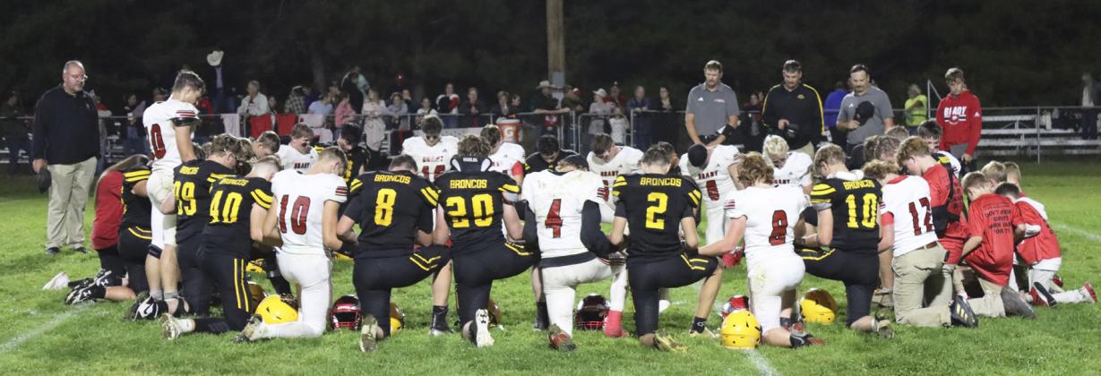 The Mullen Broncos and Brady Eagles gather to pray following the football game last Thursday. Gerri Peterson
