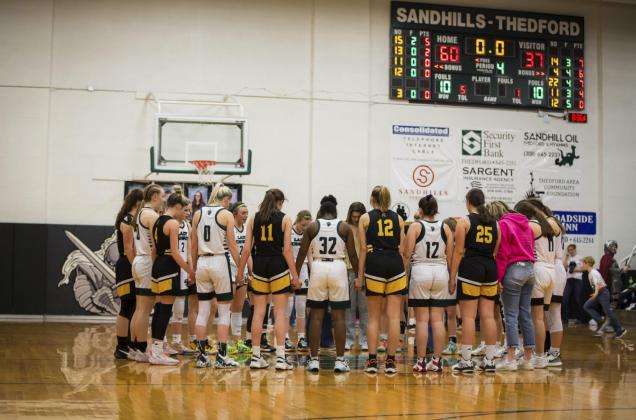 The Lady Broncos and Sandhills/Thedford Knights pray together after their subdistrict final game. Megan Andersen