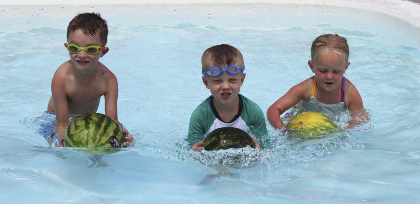 L-r: Jepson Boyer, Finnegan Connealy and Harper Barnes competing in the 4-6 year old Watermelon Race in the baby pool.