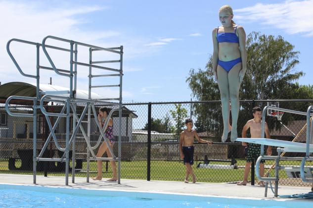 Ava Walz jumps off the board straight as a toothpick while competing in the Smallest Splash.