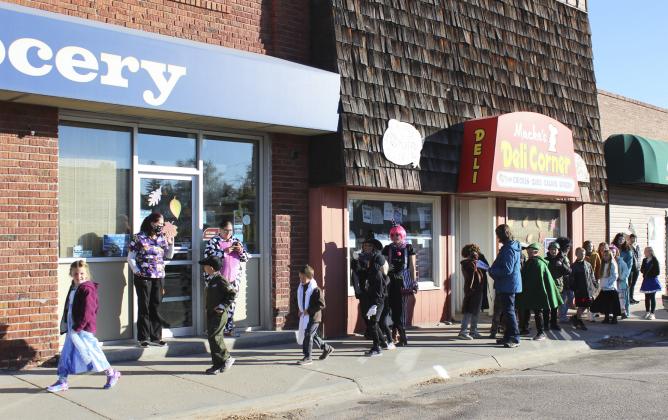 The Mullen Elementary students paraded in front of the downtown businesses Monday morning and then sang Halloween songs led by K-8 Music teacher Caroline Durfee. Gerri Peterson