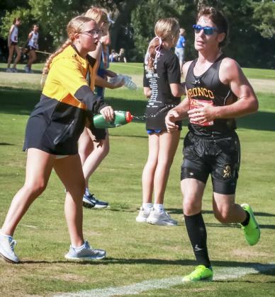Hunter Brown gets a squirt of water for a cool down and words of encouragement from teammate Riley Hegland last week. Carolee Brown Photography