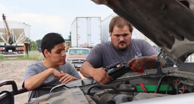 Chris Wurm and Matthew work on a pickup last Thursday.