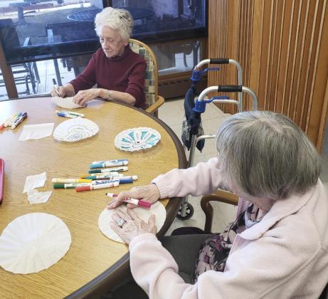 Wanda Mackley (left) and Sharon Carson working on our snowflake craft.