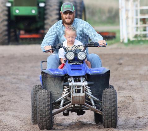 The Mullen Fun Day’s evening entertainment was the 4 Wheeler Rodeo on Saturday, July 4th, where David Kraye placed 1st, Ty Kvanvig 2nd and Jason Brown 3rd. David also won the dual race held as the final event. Pictured above is Devan Polt and his son Arthur on their way to the finish line in the hangman race. Gerri Peterson
