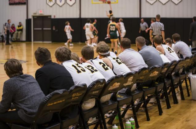 The boys’ bench watches the game last Tuesday.