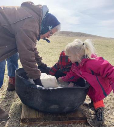 Violet and Aiden Stichka mixing up the salt and mineral with Great-Grandma Barb Stichka. Mendy Stichka