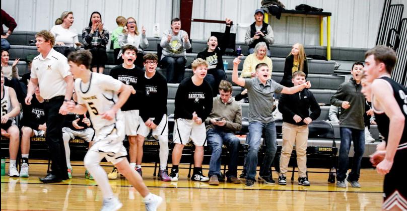 The crowd and bench cheer during the Broncos’ third quarter run against Twin Loup last Tuesday. Carolee Brown Photography