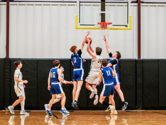 Jacob Walker makes a move to the basket between Hershey defenders last Friday night. Carolee Brown Photography