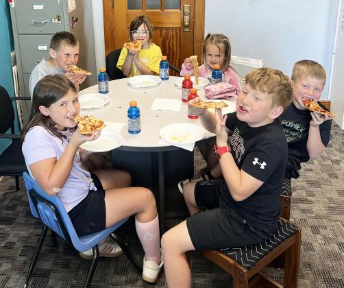 Pictured clockwise around the table from bottom left: Zandra Hebbert, Luke Cox, Nora Pohot, Stevie Johnson, Finnegan Connealy, Harrison Vinton. Brett Mauler