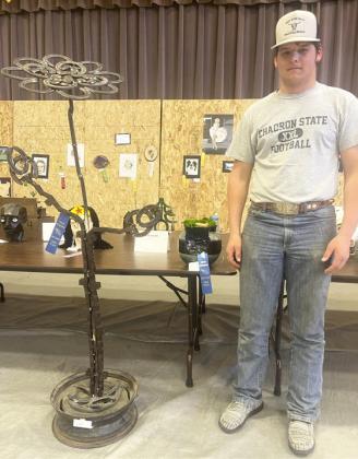 Deacon DeNaeyer with a couple of his favorite 3-D pieces. Gerri Peterson