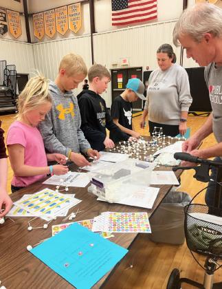Danielle Peterson, Teal Peterson, Duke Miller and Kyler Marsh try their hand at Marshmallowhedron with Mr. Taylor
