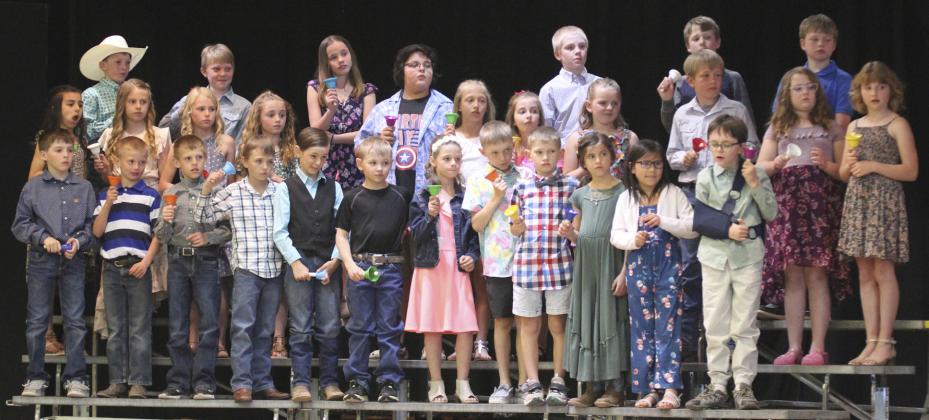 2nd/3rd graders play Somewhere Over the Rainbow on hand bells, pictured back row l-r: Duke Miller, Gus Wingebach, Logan Moore, Jedd Kraus, Cylas Dent, Jackson Newman. Middle: Mia Roman, Kaisley Phipps, Ayden Lee, Avery Vinton, Hunter Gray, Emri Dent, Lillian Ericksen, Ella Walz, Caleb Deibler, Taylor Cash, Elle Gracey. Front: Zach Hicks, Ryden Ourada, Luke Cox, Jaxyn Evans, Tuff Pettit, Tripp Jewell, Keira Kearns, Kyler Marsh, Cooper Phillips, Finley Mundorf, Natalee Walker, Samuel Hessin.