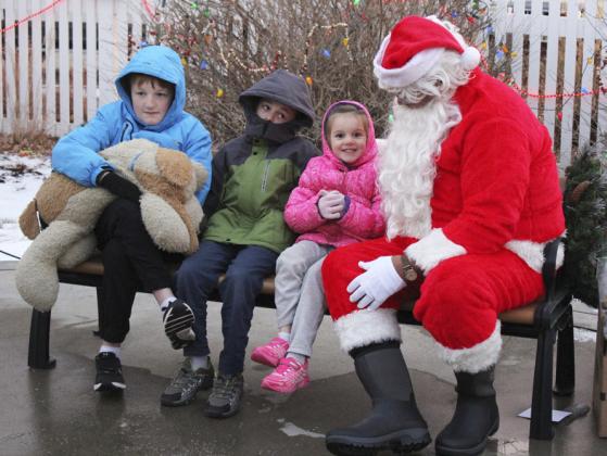 Nathan, Samuel and Anna Hessin visit with Santa.