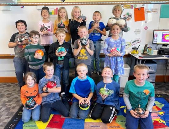 Second graders paint pumpkins