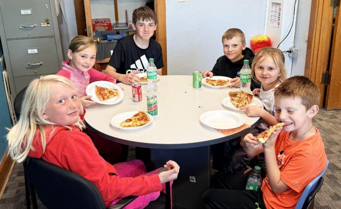 Pictured clockwise around the table from bottom left: Daryl Deibler, Brogan Jewell, Zach Hicks, Trent Cox, Doris Boland, Clay Cribelli. Brett Mauler