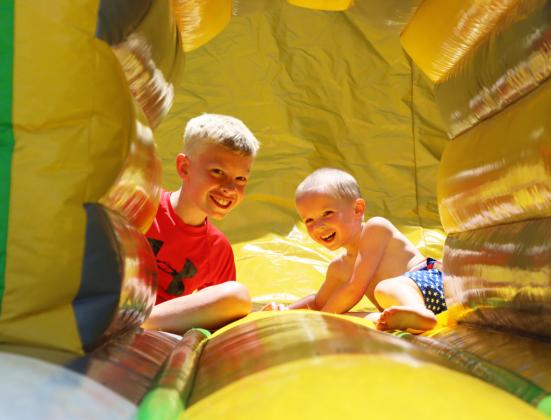Two of Lyle and Twila Phillips’ grandsons, Cameron Plummer and Trey Carlton, enjoy one of the bounce houses that was set up at the Hooker County Fairgrounds during the Mullen Fun Day on the 4th of July. Gerri Peterson