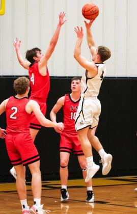 Alex Werner with a jump shot against Anselmo-Merna. Carolee Brown Photography