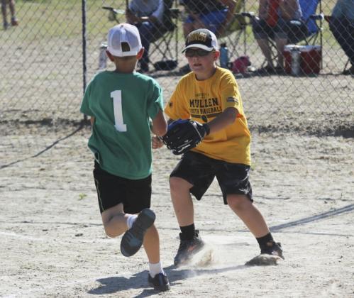 catcher Collin Donohoe runs down a Thedford player for an out in the coach pitch game at Thedford on June 10