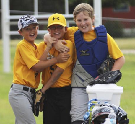 Ben Werner and Brandon Hardin celebrate with Jack Coble (center) after Jack dove for a catch from third base for the last out of the inning at Thedford