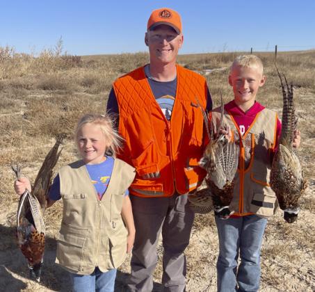 Danielle, Dane and Teal Peterson after a successful youth pheasant hunt.