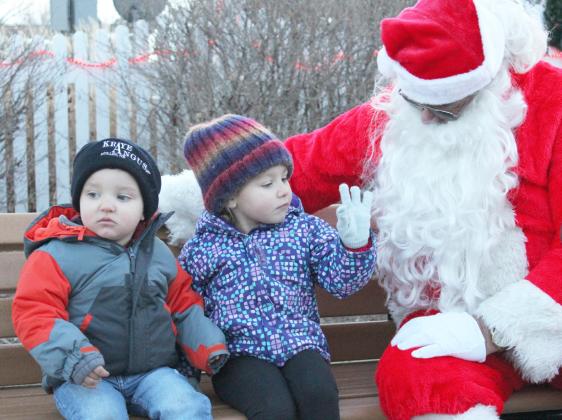 Quinley Schmid tells Santa that she is 3 years old while visiting him with brother Huxton