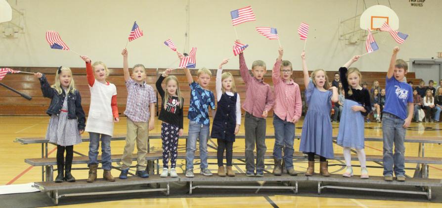 Mullen first graders sing “You’re a Grand Old Flag,” pictured l-r: Charlotte Connealy, Anna Ridenour, Tate Phillips, Aurora Polt, Jaxson Barnes, Meyer Vinton, Merick Lattin, Cooper Ourada, Kinley Crisp, Brogan Jewell, Kayden Evans. Gerri Peterson