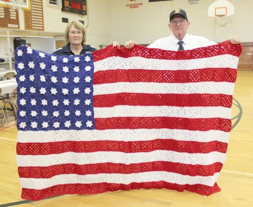 Like a Quilt of Valor, Daryl Starr was presented this afghan that Cathy Nichols (also pictured) made, which they called a covering of honor.