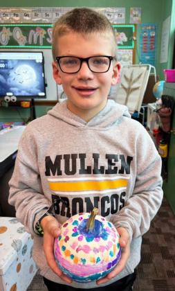 Mullen 2nd graders turned ordinary pumpkins into unique works of art with paint last week. Pictured are Brogan Jewell (left) and Cooper Ourada.