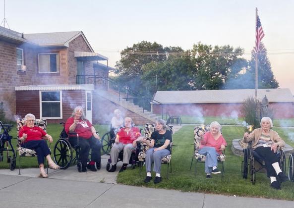 Residents with sparklers. Thanks to Jeannette Naillon, Tammy Dancer and Chris Baker for the 4th of July activity preparation!