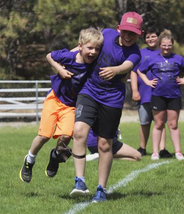 Hold on Killian! Fifth grader Colin Connealy took the threelegged race to a whole other level last week at the Mullen Elementary Field Day when he hoisted his teammate, first grader Killian Kearns, up and just carried him instead! Gerri Peterson